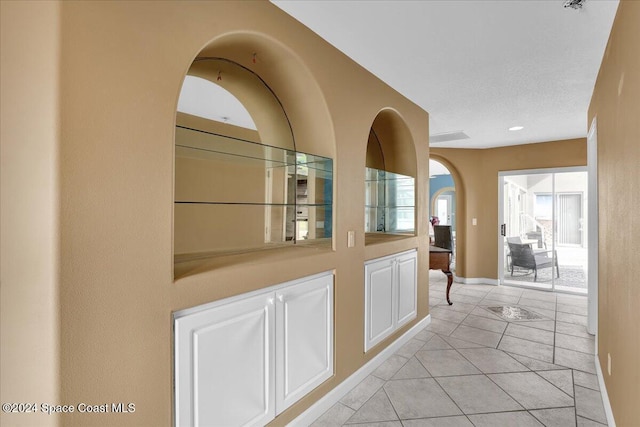 hall featuring light tile patterned flooring