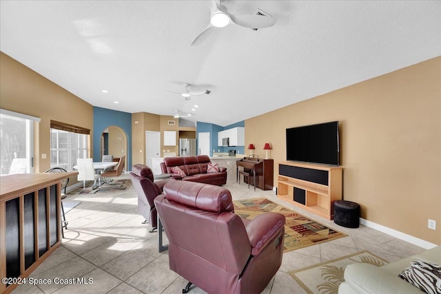 tiled living room featuring vaulted ceiling and ceiling fan