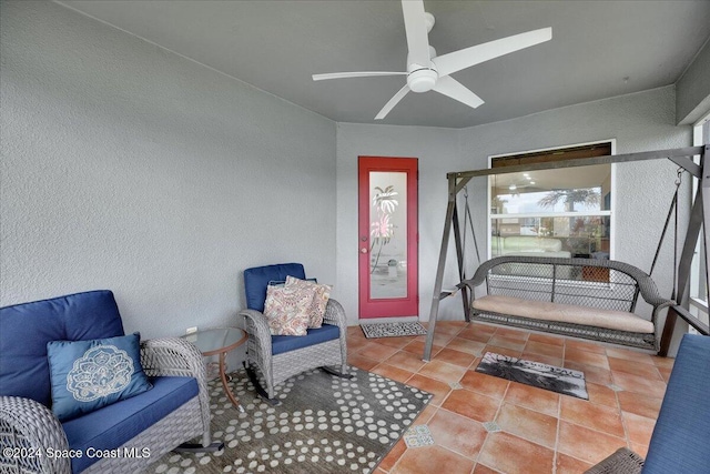 sitting room with tile patterned floors and ceiling fan