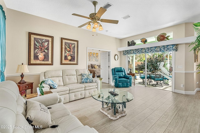 living room with light hardwood / wood-style floors and ceiling fan