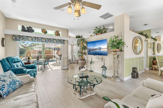 living room featuring ceiling fan and light hardwood / wood-style floors