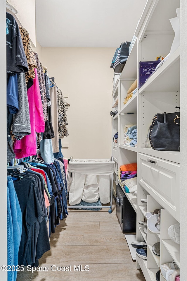 spacious closet featuring light hardwood / wood-style floors