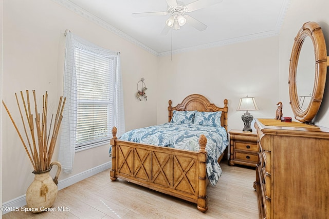 bedroom with light wood-type flooring, ceiling fan, and ornamental molding