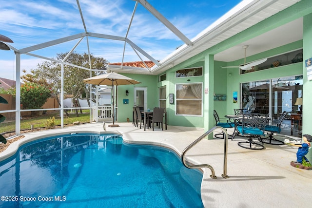 view of pool with a lanai, a patio area, and ceiling fan