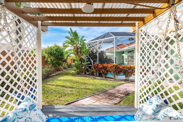 view of yard featuring a pergola and glass enclosure