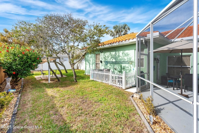 view of yard featuring a lanai and a patio