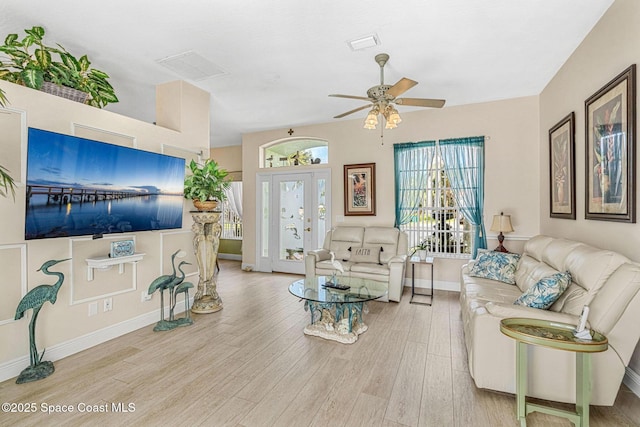 living room with light hardwood / wood-style floors and ceiling fan