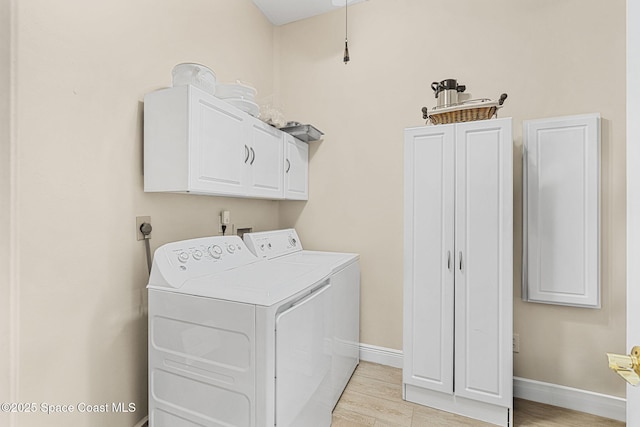 washroom with cabinets and separate washer and dryer