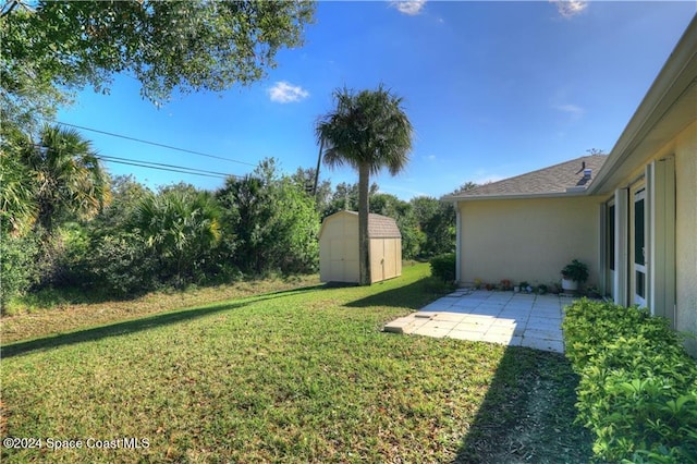 view of yard featuring a patio area and a storage shed