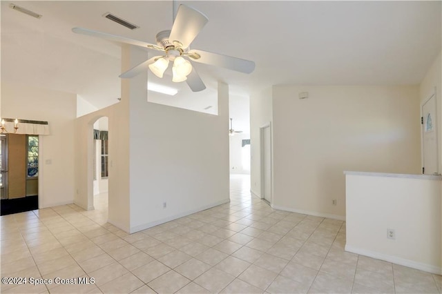 spare room featuring vaulted ceiling, ceiling fan, and light tile patterned flooring