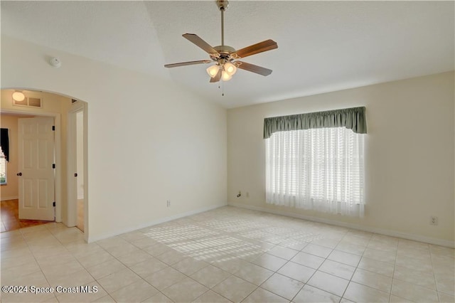 tiled spare room with ceiling fan