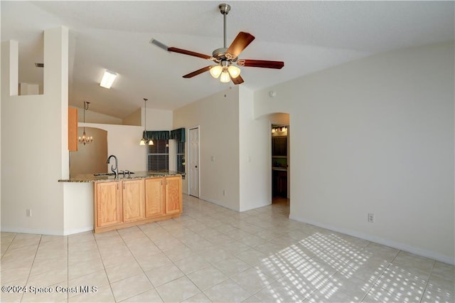 kitchen featuring light brown cabinets, sink, vaulted ceiling, light tile patterned floors, and ceiling fan with notable chandelier