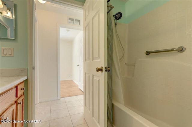 bathroom featuring tile patterned flooring, vanity, and shower / bathtub combination