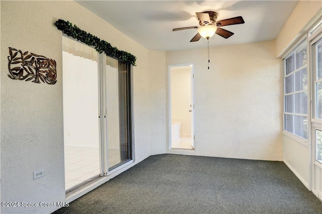 carpeted empty room featuring ceiling fan