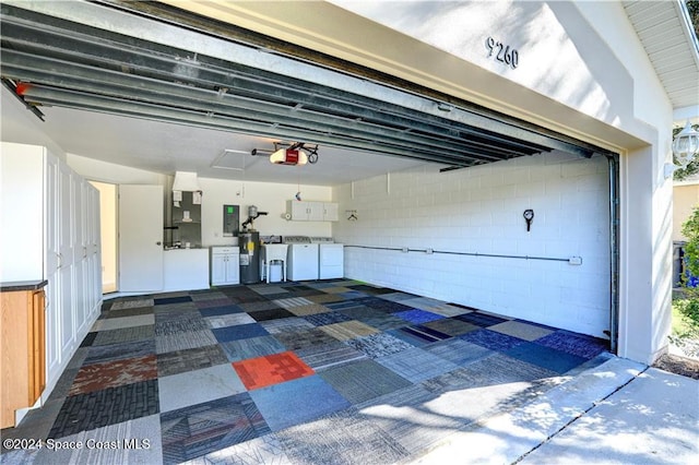 garage with washing machine and clothes dryer, ceiling fan, water heater, electric panel, and a garage door opener