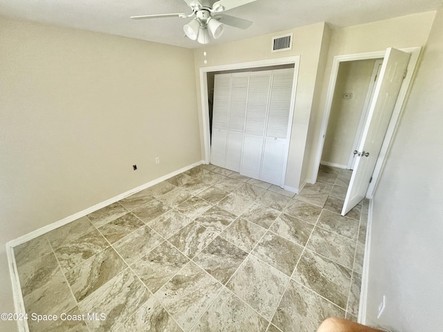 unfurnished bedroom featuring a closet and ceiling fan