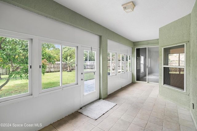 unfurnished sunroom with plenty of natural light