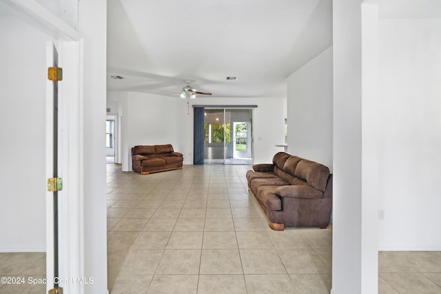 tiled living room featuring ceiling fan