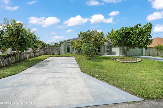 obstructed view of property with a front yard and a garage