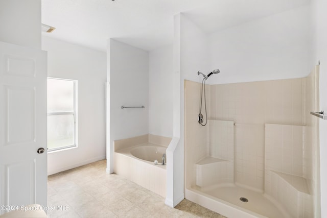 bathroom featuring independent shower and bath