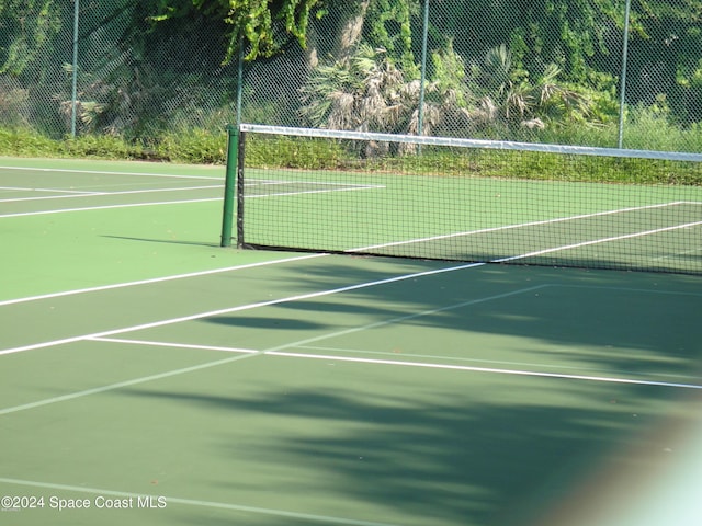 view of tennis court featuring fence