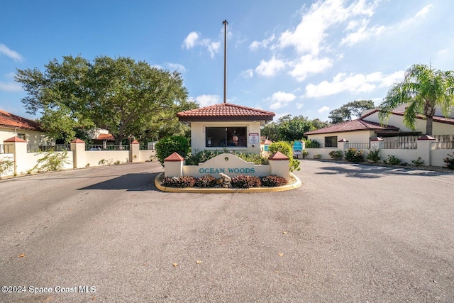 view of front of home featuring a tile roof and fence