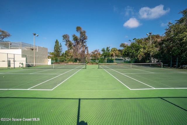 view of tennis court featuring fence