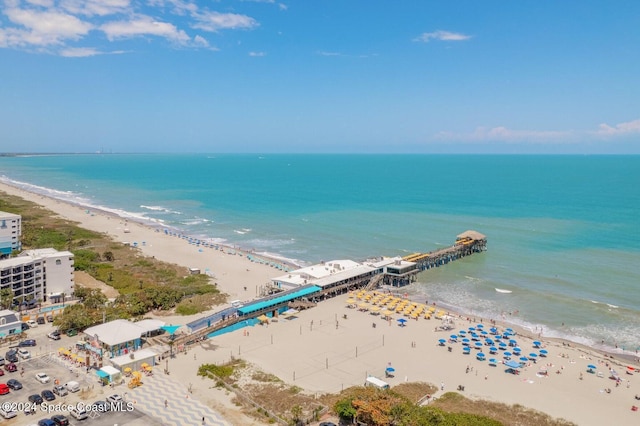 birds eye view of property with a view of the beach and a water view