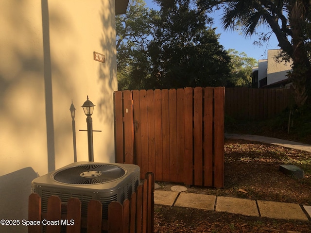 exterior details with central AC unit and fence