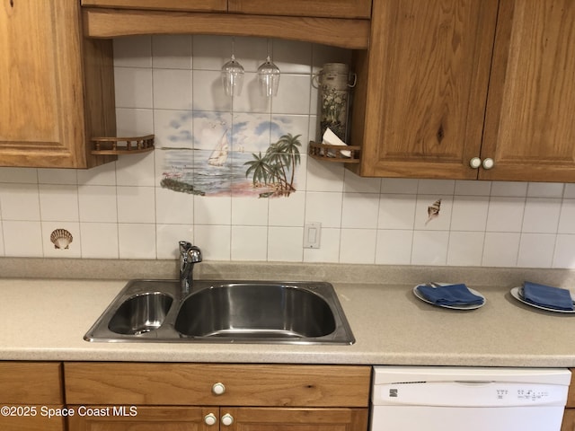 kitchen featuring a sink, backsplash, brown cabinetry, and white dishwasher