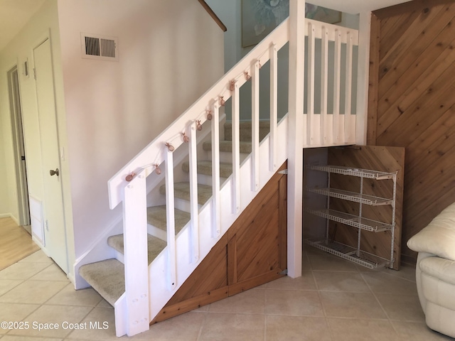 staircase featuring tile patterned flooring and visible vents