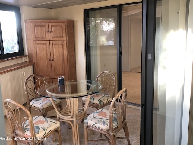 dining room with light colored carpet