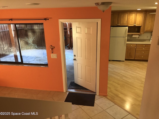 entryway with light tile patterned floors