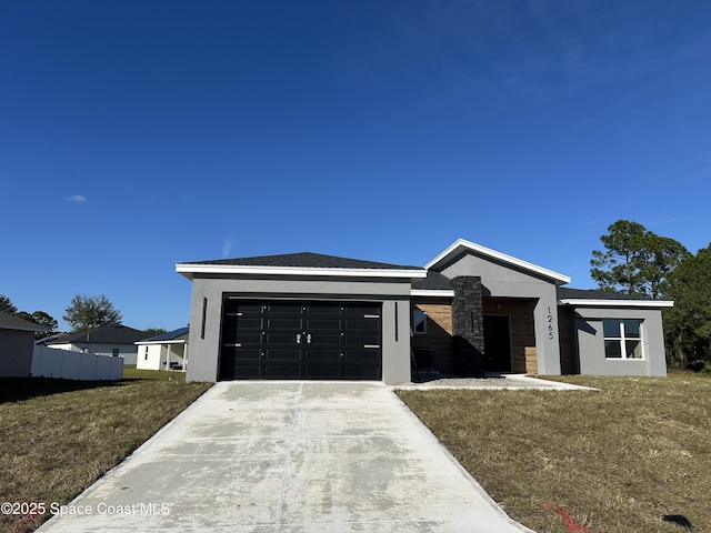 view of front of home featuring a garage and a front lawn