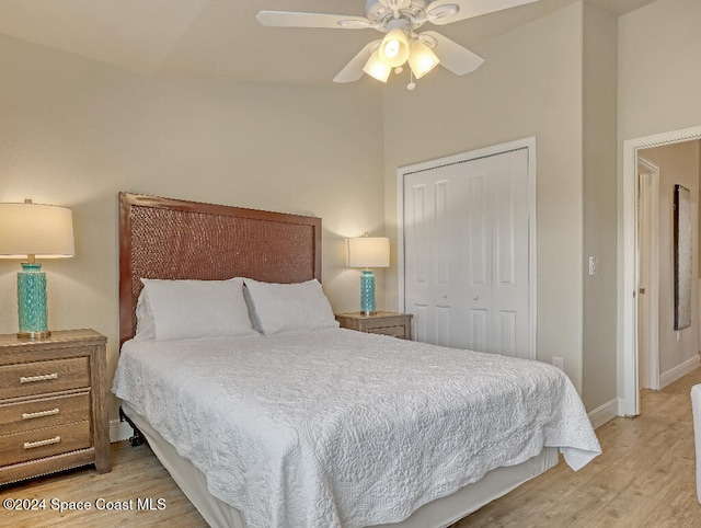 bedroom with ceiling fan, a closet, and light hardwood / wood-style floors