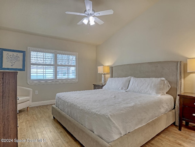 bedroom with light wood-type flooring, ceiling fan, and lofted ceiling