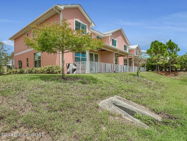 exterior space featuring covered porch and a yard