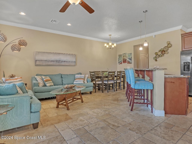 living room featuring ceiling fan with notable chandelier and crown molding