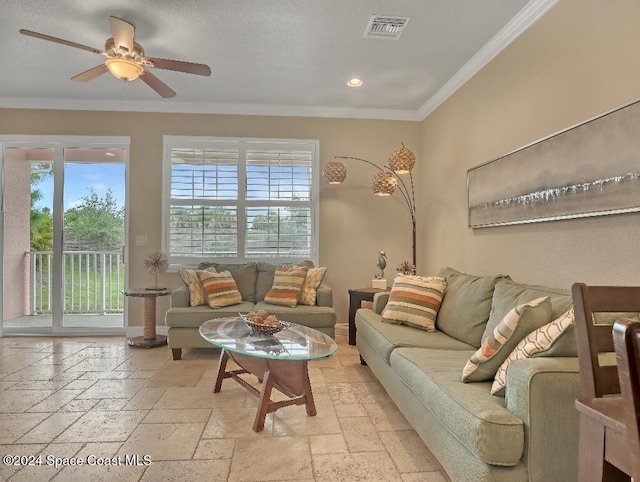 living room featuring crown molding, ceiling fan, and a healthy amount of sunlight