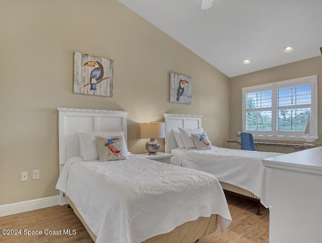 bedroom featuring vaulted ceiling and hardwood / wood-style flooring