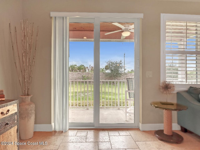 doorway to outside featuring ceiling fan