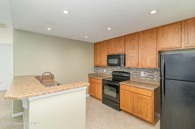 kitchen featuring a kitchen bar, decorative backsplash, a sink, a peninsula, and black appliances