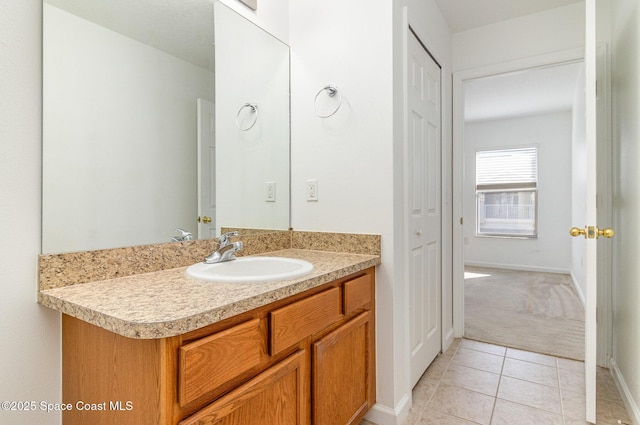 bathroom with tile patterned flooring, vanity, and baseboards