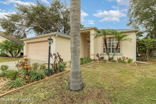 view of front facade featuring a front lawn, a garage, driveway, and stucco siding