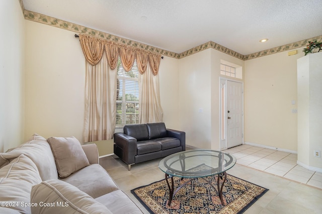 living room with light tile patterned floors and a textured ceiling