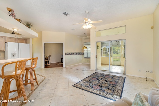 interior space featuring ceiling fan and a textured ceiling