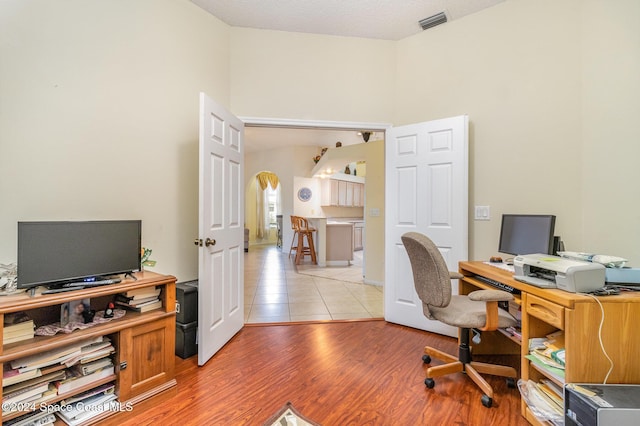 office space featuring light hardwood / wood-style floors and a textured ceiling