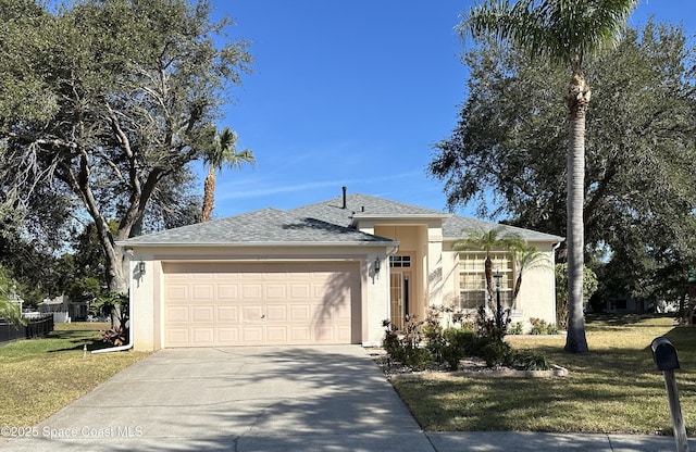 ranch-style house featuring a garage and a front lawn