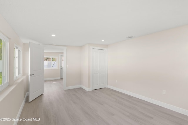 spare room with light hardwood / wood-style flooring