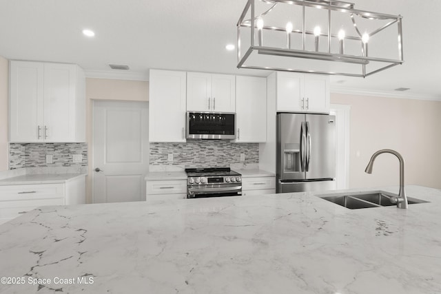 kitchen with crown molding, sink, white cabinets, and stainless steel appliances